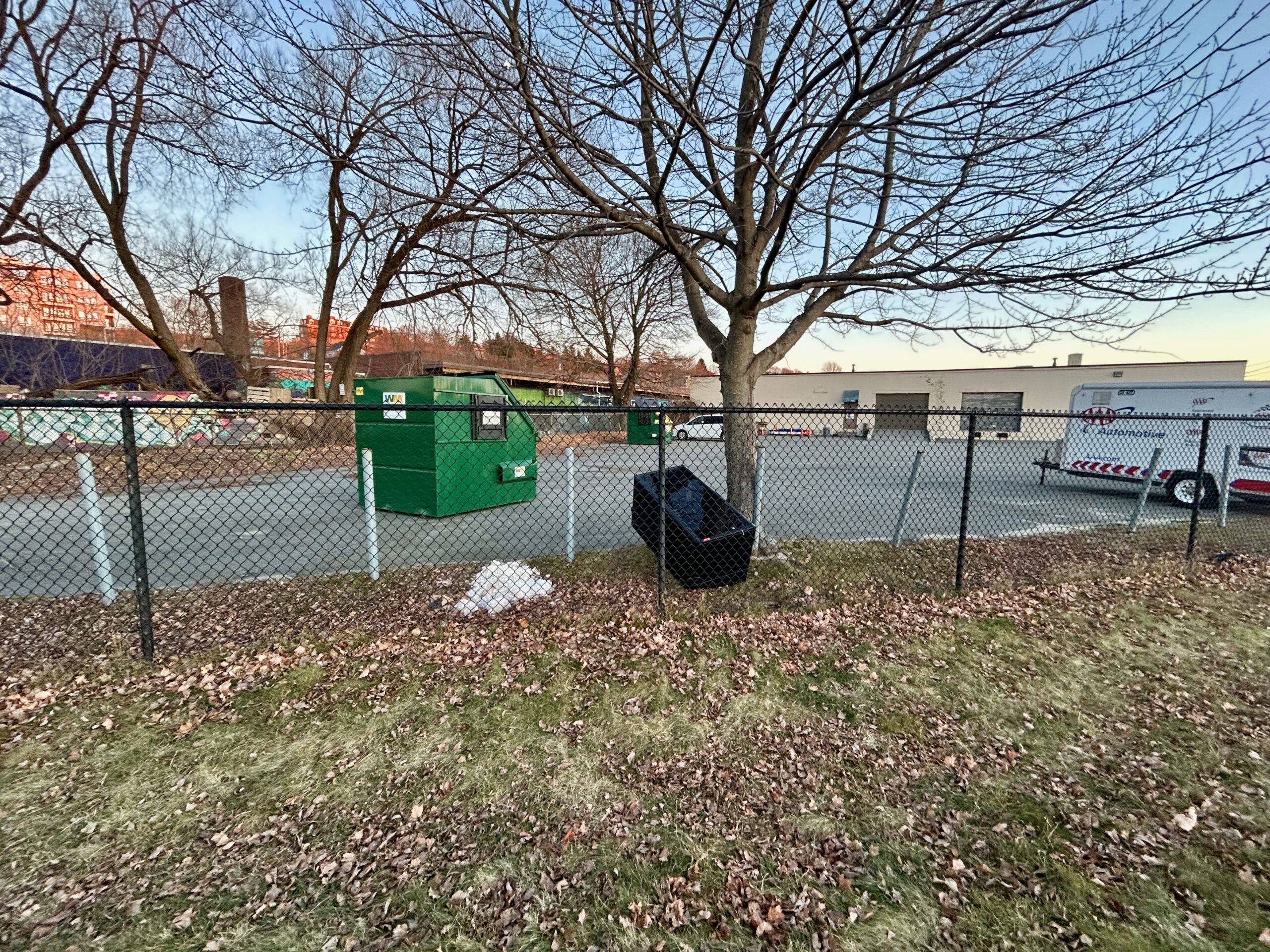 Server rack sitting near dumpster. 